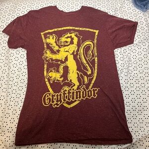 Maroon t shirt with Harry Potter Gryffindor House symbol.
